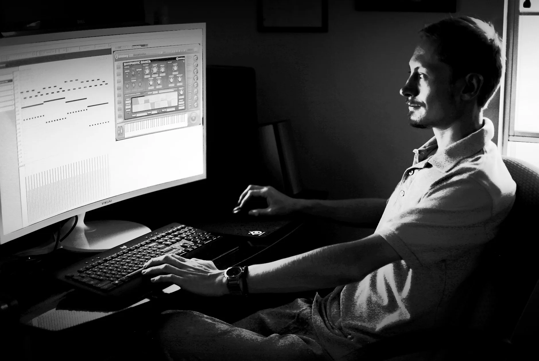 High-contrast black-and-white editorial treatment of Ryan working in Cubase
